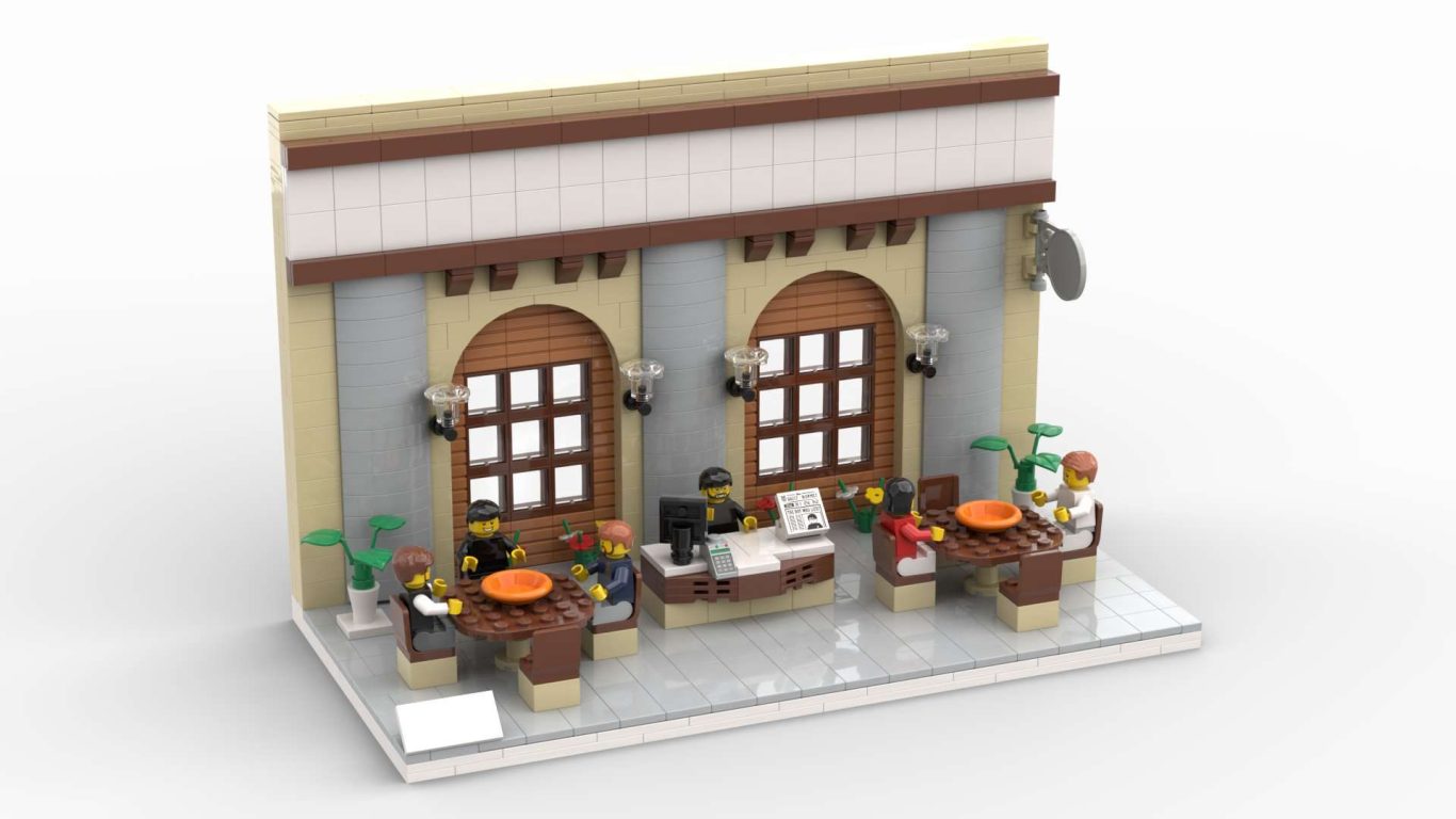 Edificio de Lego con detalles arquitectónicos y mesas en un restaurante.