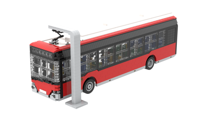 Autobús de juguete en colores rojo y negro con un poste de carga al lado.