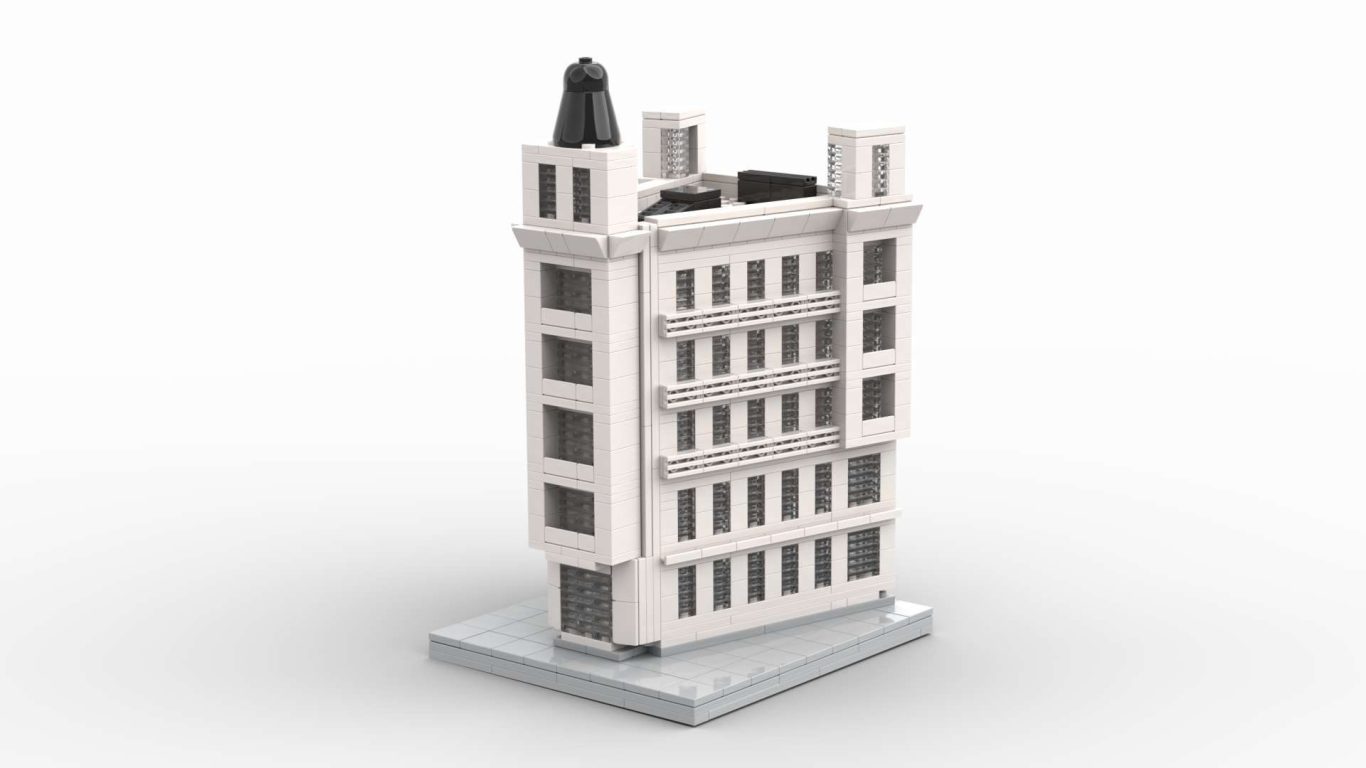 Edificio de estilo moderno, de color blanco, con detalles arquitectónicos en la parte superior.