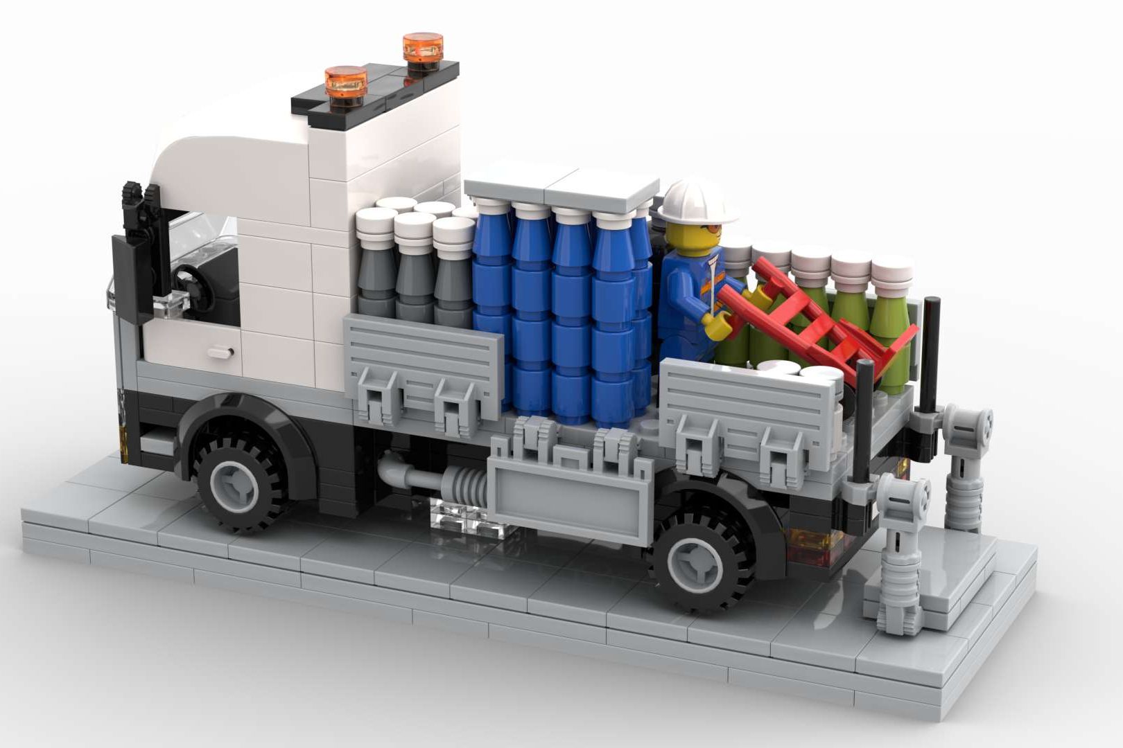 Camión de juguete con barriles de colores en la parte trasera y detalles mecánicos.